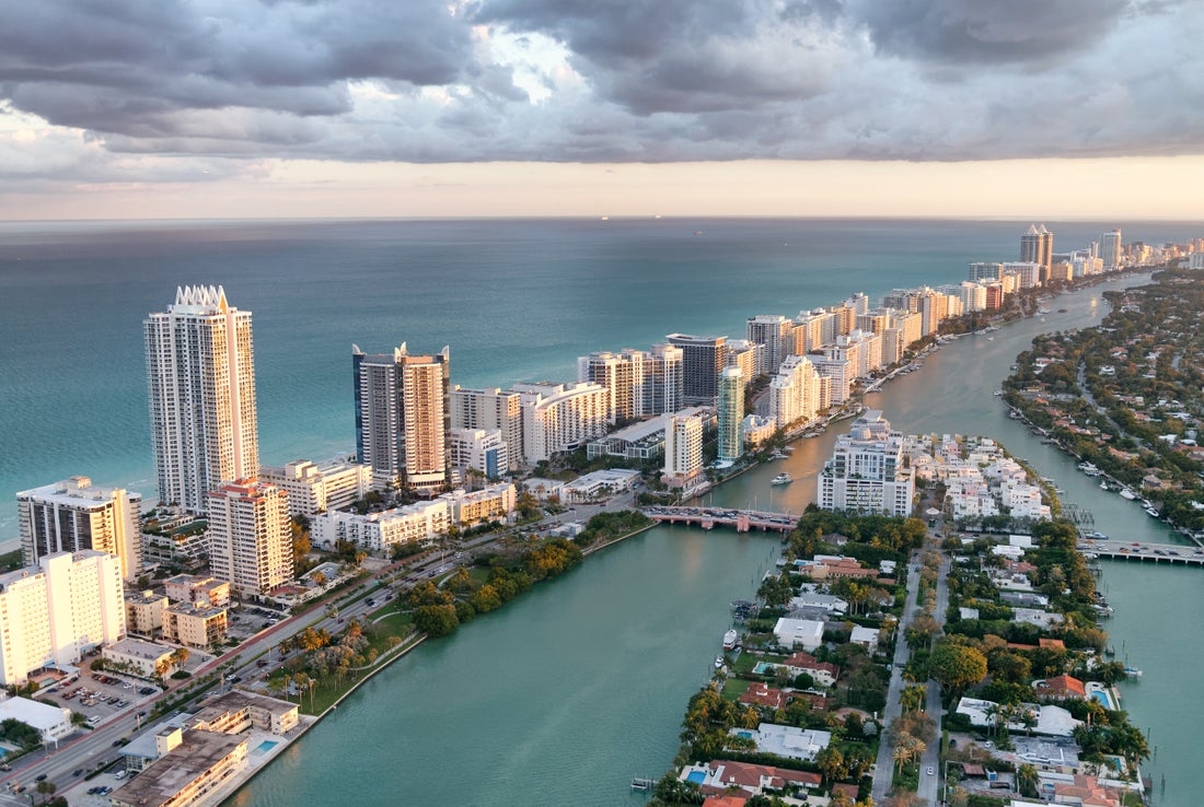 a large body of water with a city in the background